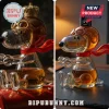 Clear glass Snoopy character decanter wearing aviator goggles and a red scarf with an amber liquid interior.!