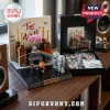 Pink Floyd The Wall themed LEGO brick construction set with pig figure, prism, and two minifigures on a wooden surface.!