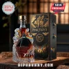 Pink Floyd 60th anniversary glass whiskey bottle with prism and winged pig motifs next to matching black decorative box.!