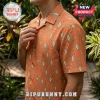 Man wearing short-sleeve button-down shirt with burnt orange fabric and repeating teal and cream diamond ikat patterns.!