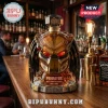 Predator 40th anniversary glass whiskey decanter with glowing red eyes and tribal script base on a wooden bar counter.!