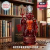 Red glass devil figurine decanter with trident and soccer ball topper next to a labeled box on a bookshelf background.!
