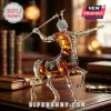 Centaur-shaped glass whiskey decanter with silver torso holding a spear, standing on a wooden desk with leather books.!