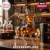 Rémy Martin centaur glass whiskey decanter holding a gold spear on a wooden desk with a library background.!