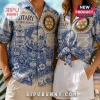 Couple wearing blue and white Rotary International print button-down shirts featuring globe graphics and text details.!