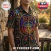 Man wearing short-sleeve button-up shirt with stained-glass style print featuring the band name RUSH and gold figure icon.!