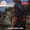 Man wearing a short-sleeve shirt with stained glass Rush band imagery including a star, a crown, and an eagle icon.!