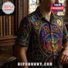 Man wearing a short-sleeve shirt with a stained-glass RUSH rock band logo, star-man figure, crown, and owl motif patterns.!