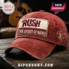 Distressed red baseball cap featuring a Rush The Spirit of Radio patch and Starman logo on a wooden surface.!