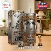 San Antonio Spurs commemorative stainless steel tumbler with championship ring and mini trophy on a wooden table.!