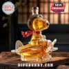 Snoopy Flying Ace glass decanter filled with amber liquid on a wooden surface, featuring pilot goggles and a red scarf.!