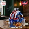 Space marine helmet shaped glass decanter featuring red, blue, and gold accents with a silver skull emblem on a table.!