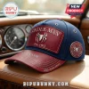 Blue and maroon leather-style Spider-Man baseball cap with silver metal emblem and custom text space on car dashboard.!