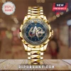 Gold-toned Star Trek 60th anniversary analog watch with blue textured dial, Federation delta logo, and metal link band.!