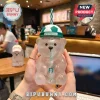 Clear Starbucks bear-shaped plastic cup with a green and white soccer ball lid and matching striped drinking straw.!