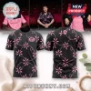 Black and pink floral patterned football jersey featuring a crest, Hummel logo, and short sleeves on a white background.!