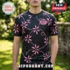 Black and pink Sunderland AFC soccer jersey with floral patterns and Hummel logo worn by a man against a blurred garden.!