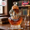 Faceted crystal dog whiskey decanter wearing an orange and white checkerboard baseball cap with a T logo.!