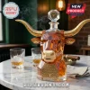 Amber glass bull-shaped whiskey decanter with gold horns and commemorative 1893-2026 anniversary plaque on marble table.!