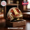 Gold Texas Longhorns 2026 baseball championship ring with red gemstone, NCAA logo, and clear side stones in wood box.!