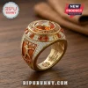 Gold Texas Longhorns NCAA WCWS 2026 championship ring with orange stones, pavé diamonds, and Longhorn logo on wood surface.!