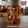 Amber glass tumbler featuring raised gold relief of Texas Longhorns logo, softball bats, balls, and National Champions text.!