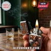 Zippo Texas Longhorns metal lighter with a flaming wick, embossed longhorn head, football, and state map on wood table.!