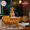 Yellow Submarine shaped glass decanter featuring Beatles portraits, Revolver 60 branding, and floral motifs on wood table.!