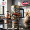 Orange General Lee car embossed tumbler with brass-tone lid, straw, and blue handle, featuring 1983-2026 text on kitchen counter.!