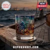 The Kraken whiskey glass featuring iridescent octopus and ship artwork on a wooden boat deck at sunset.!