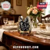 Kraken Black Spiced Rum stemless wine glass with gold and black octopus graphic sitting on a wooden dining table.!