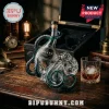 Kraken Black Spiced Rum glass bottle shaped like a deep blue octopus on a wooden desk with a matching crystal tumbler.!