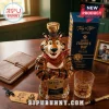 Tony the Tiger shaped glass whiskey bottle with gold stopper, branded box, and matching etched glass on wooden desk.!