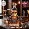 Top Gun 50th anniversary faceted crystal whiskey decanter shaped like Maverick in sunglasses on a wooden desk.!