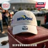 Beige 47 brand baseball cap with Skydome embroidered on the front, resting on a red plastic cooler outdoors.!