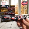 1:64 scale Toyota GR010 Hybrid Le Mans die-cast car in white and red livery held in hand before its blister pack packaging.!