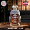 Megatron-shaped glass whiskey decanter with red eyes and 2007-2027 20th Anniversary label on wooden table background.!