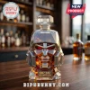 Megatron-shaped glass whiskey decanter with faceted edges, red eyes, and a 2007-2027 20th anniversary plaque on a bar table.!
