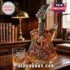 U2 50th anniversary guitar-shaped glass whiskey bottle with Joshua Tree etching and matching Zoo TV rocks glass on desk.!