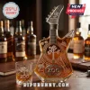 U2 50th Anniversary guitar-shaped glass whisky bottle with ZOO TV etching and matching rocks glass on wooden table.!