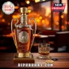 Champions League 71st anniversary whiskey bottle with trophy-shaped glass, gold stopper, and matching glass on wood table.!