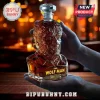 The Wolf Man glass decanter shaped like a werewolf bust filled with amber liquid against a blurred bar background.!