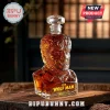 The Wolf Man shaped glass decanter containing amber liquid with a crystal stopper, set on a rustic wooden surface.!
