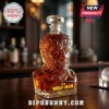 The Wolf Man glass whiskey decanter with detailed sculpted hair and teeth, filled with amber liquid on a wooden bar top.!