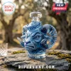 Blue glass decanter shaped like a ram head wearing a UNC sailor hat on a stone surface.!