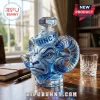 Blue glass decanter shaped like a ram head with UNC lettering on a sailor hat cap sitting on a wooden desk.!