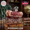 Oklahoma Sooners whiskey decanter shaped like a covered wagon with red and cream glass, inscribed with Boomer Sooner text.!