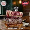 Oklahoma Sooners whiskey decanter shaped like a covered wagon with red and cream glass, inscribed Boomer Sooner on base.!