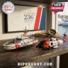 U.S. Coast Guard model cutter and helicopter on wooden table with a 236th anniversary framed sign and brass compass.!