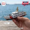 Scale model of U.S. Coast Guard cutter 1102 with white hull, red stripe, and gold mast held in a hand near the water.!
